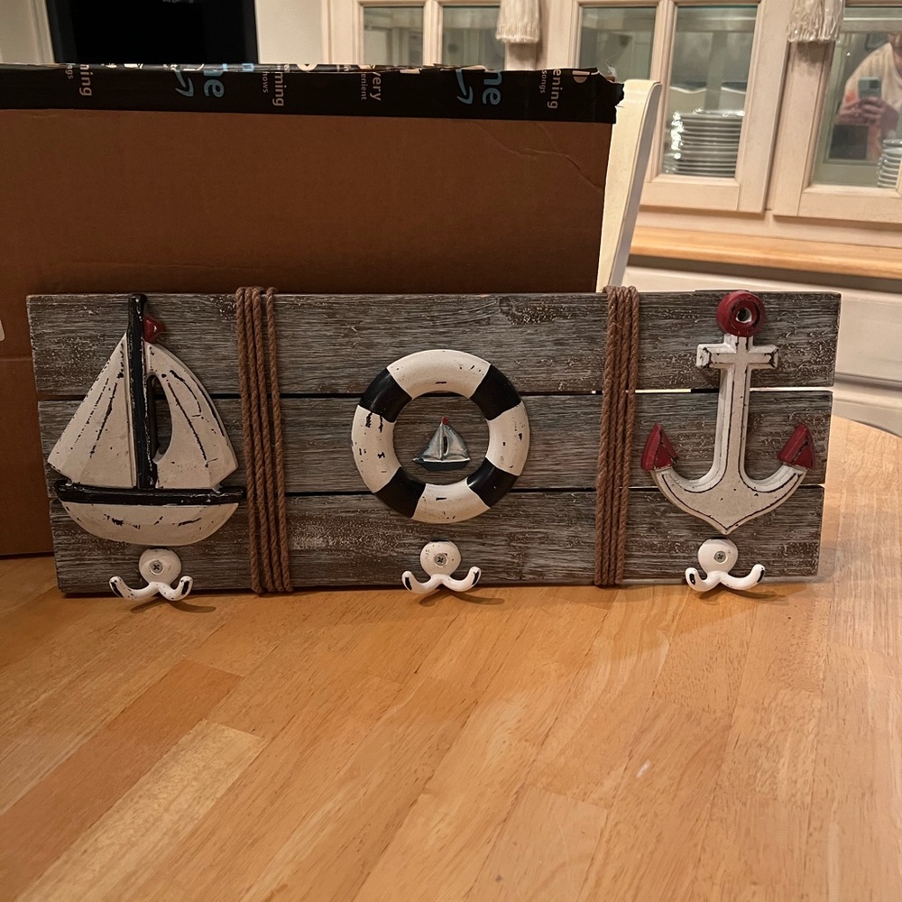 Adorable sailor hanging decor with hooks.